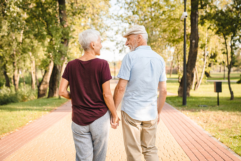 Elderly couple walking in the sun